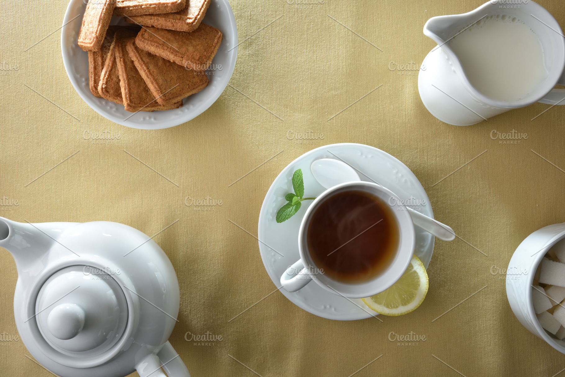 Tea and white ceramic containers on a table with tablecloth, a Food & Drink Photo by Davizro's Market