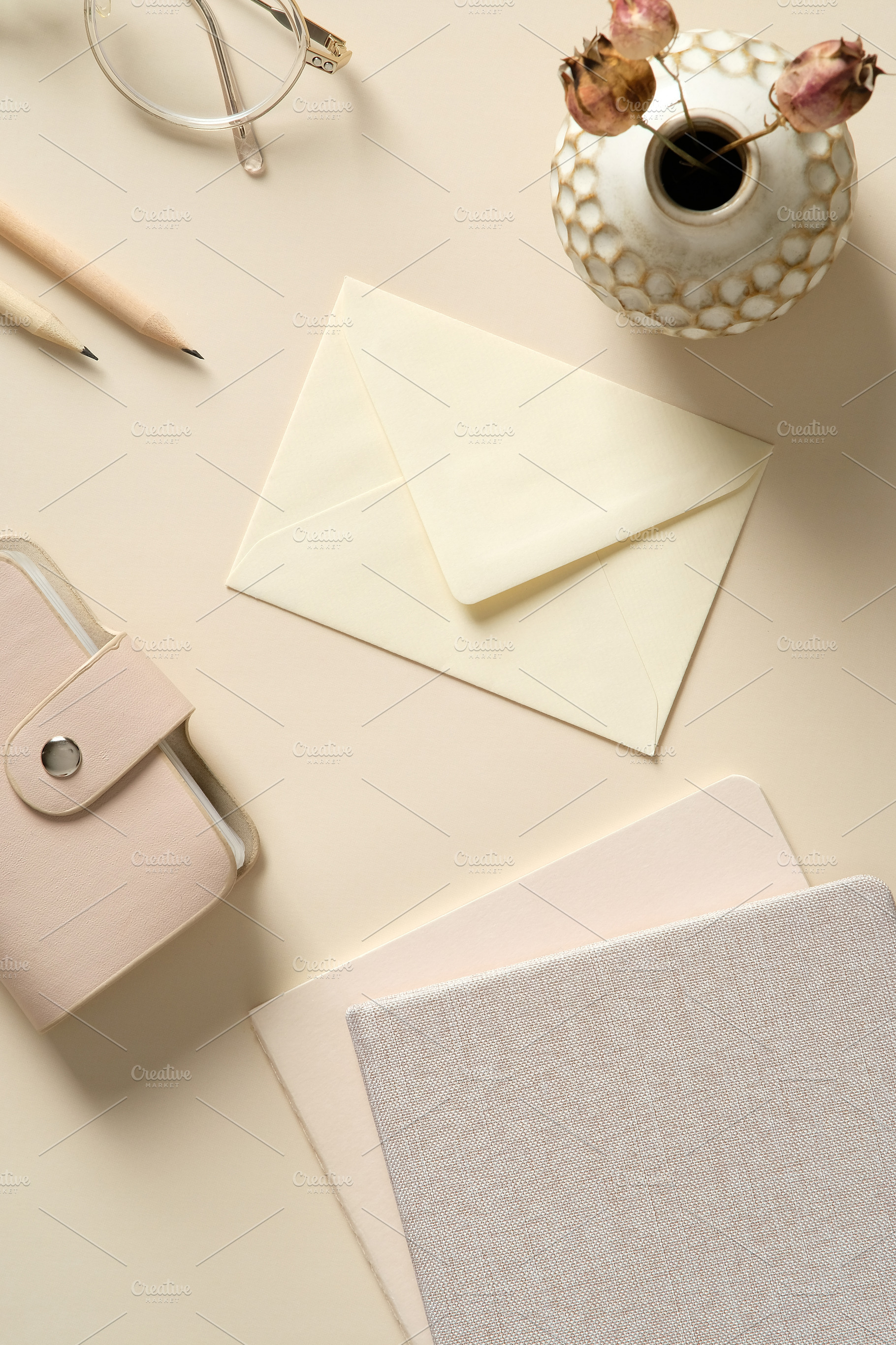 Stylish home office desk table with envelope, feminine accessories, paper noteb, a Holiday Photo by photoguns