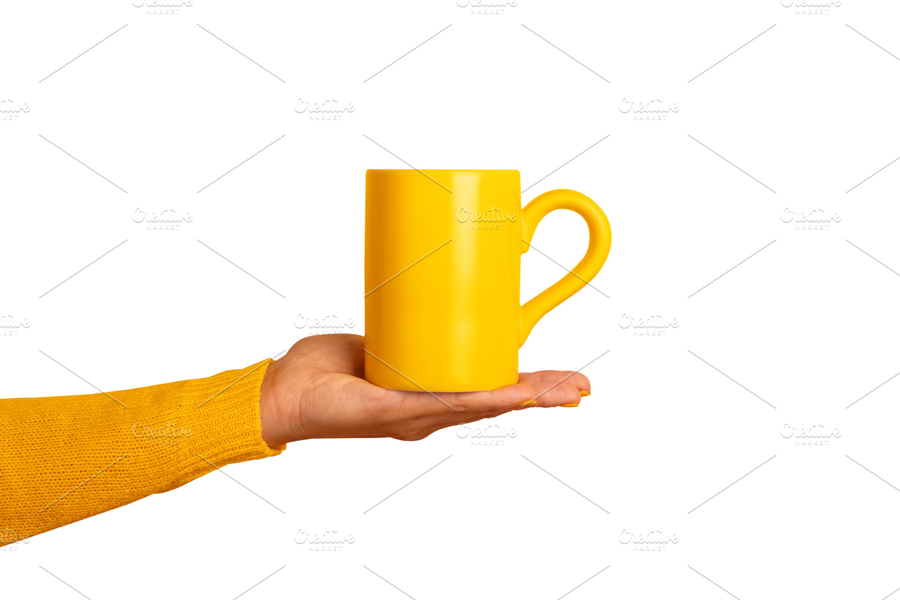 A person's hand in a yellow sleeve holds a bright yellow ceramic, a Food & Drink Photo by Ales Munt