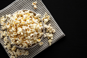 Homemade Butter Popcorn with Salt in a Bowl, top view. Copy spac, a Food & Drink Photo by LiudmylaChuhunova