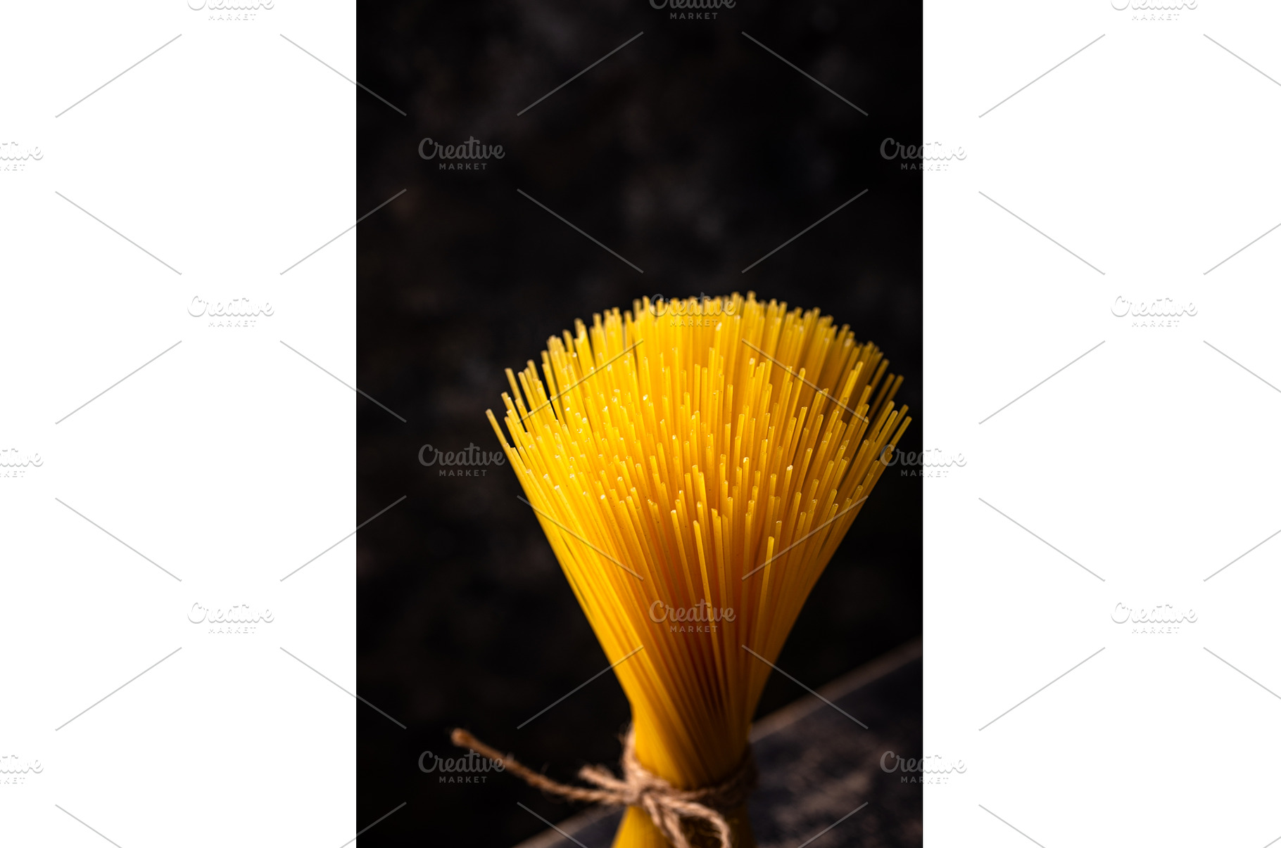 Raw uncooked sspaghetti on dark, a Food & Drink Photo by Yulia Furman