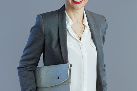 happy stylish 40 years old woman worker isolated on gray, a Business Photo by Alliance Images