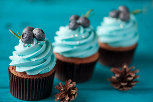 Three cupcake with blueberry cream featuring dessert, sweet, and stand