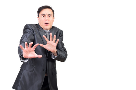 Shocked businessman gesturing and looking at camera with scared face, a Business Photo by Iván Moreno STOCK PHOTO