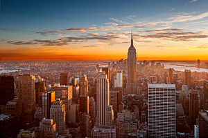 Sunset over manhattan containing sunset, sky, and skyline