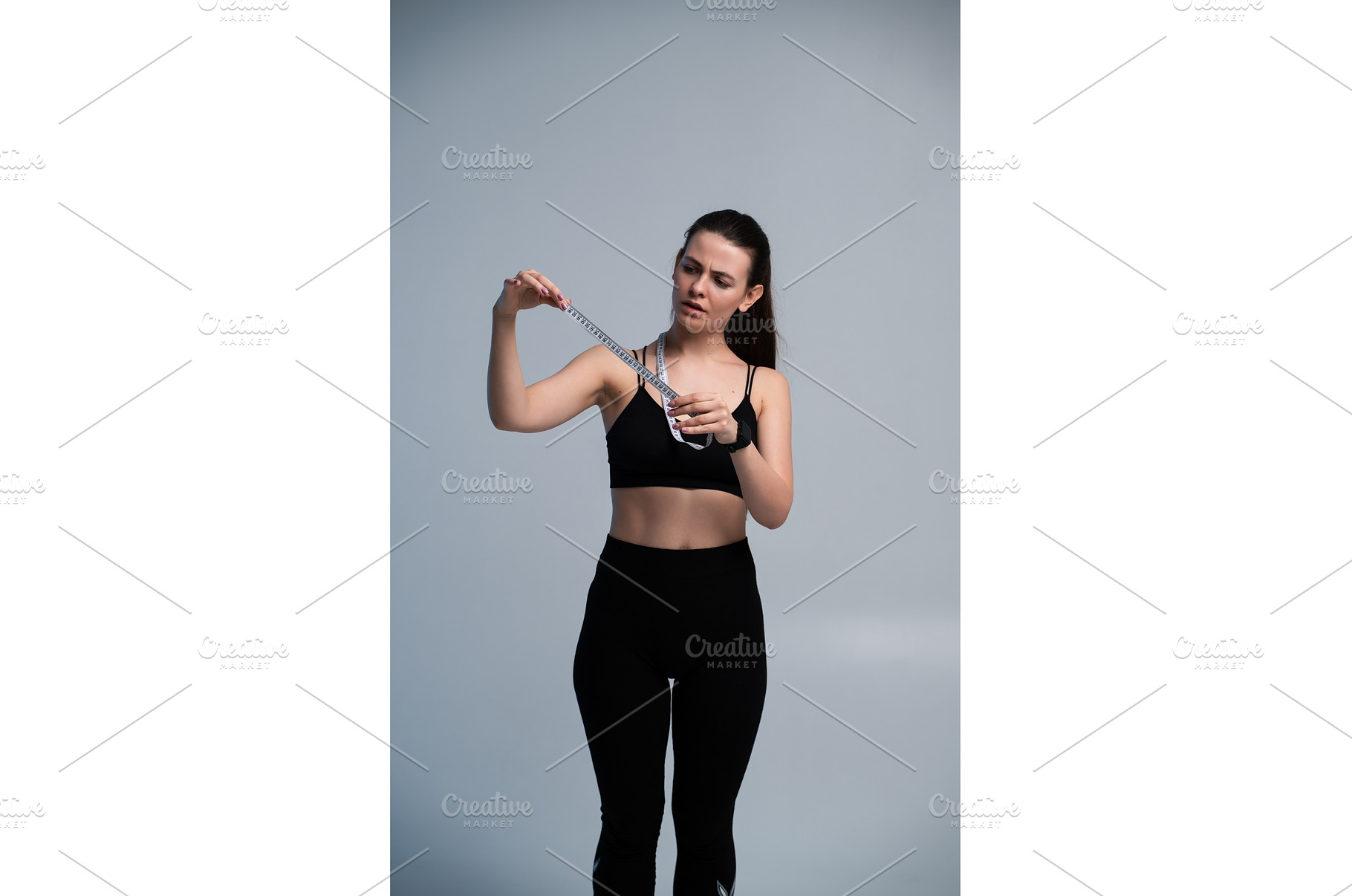 Young woman in sportswear examines a, a Sports & Recreation Photo by volodymyrshtun13795