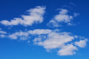 Several small cumulus clouds with soft white edges hovering agai, a Nature Photo by ndanko
