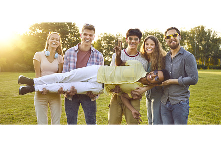 Group of happy people standing in, a Person Photo by StudioRomantic