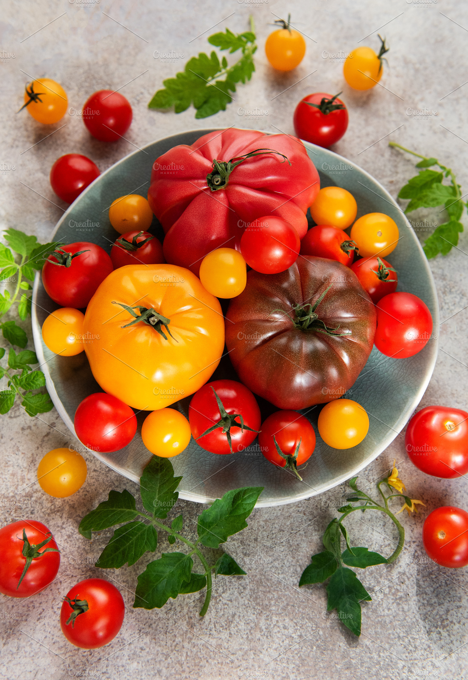 Heirloom tomatoes creating colorful harvest on plate, a Food & Drink Photo by Olena Rudo