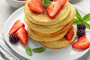 Stack of pancakes with strawberries, blackberries, and mint leav, a Food & Drink Photo by Olena Rudo