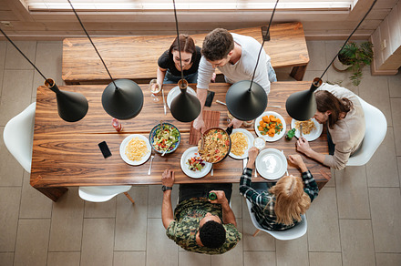 Top view of people having dinner together while sitting, a Person Photo by Dean Drobot
