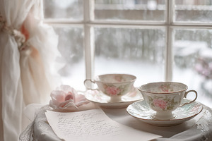 Elegant porcelain tea cups and a personal letter creating a cozy, a Photo by Studio ANNA