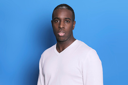 Portrait of cheerful young african-american guy wearing white casual sweater po, a Person Photo by RF Images