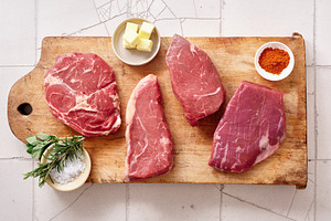 Different cuts of raw beef including rib-eye, roast beef, flank, and rump steak, a Food & Drink Photo by Asya Nurullina