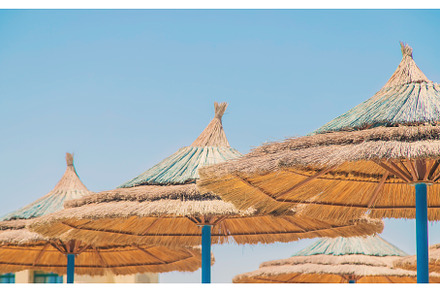 Thatched umbrellas on the beach, a Nature Photo by yanadjana