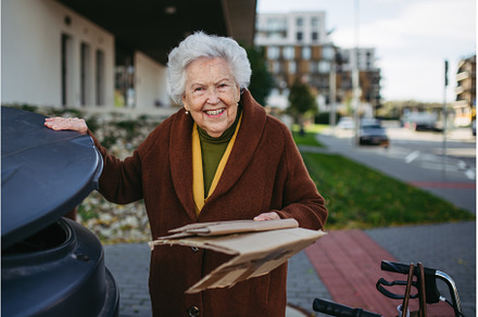 Elderly woman disposing cardboard, an Architecture Photo by HalfPoint