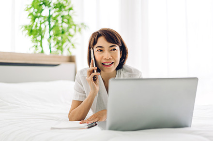 Young smiling happy beautiful asian business woman relaxing usin, a Person Photo by Art_Photo