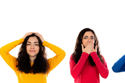 Four identical brunette girls gesticulating different emotions, a Person Photo by José Manuel Gelpi