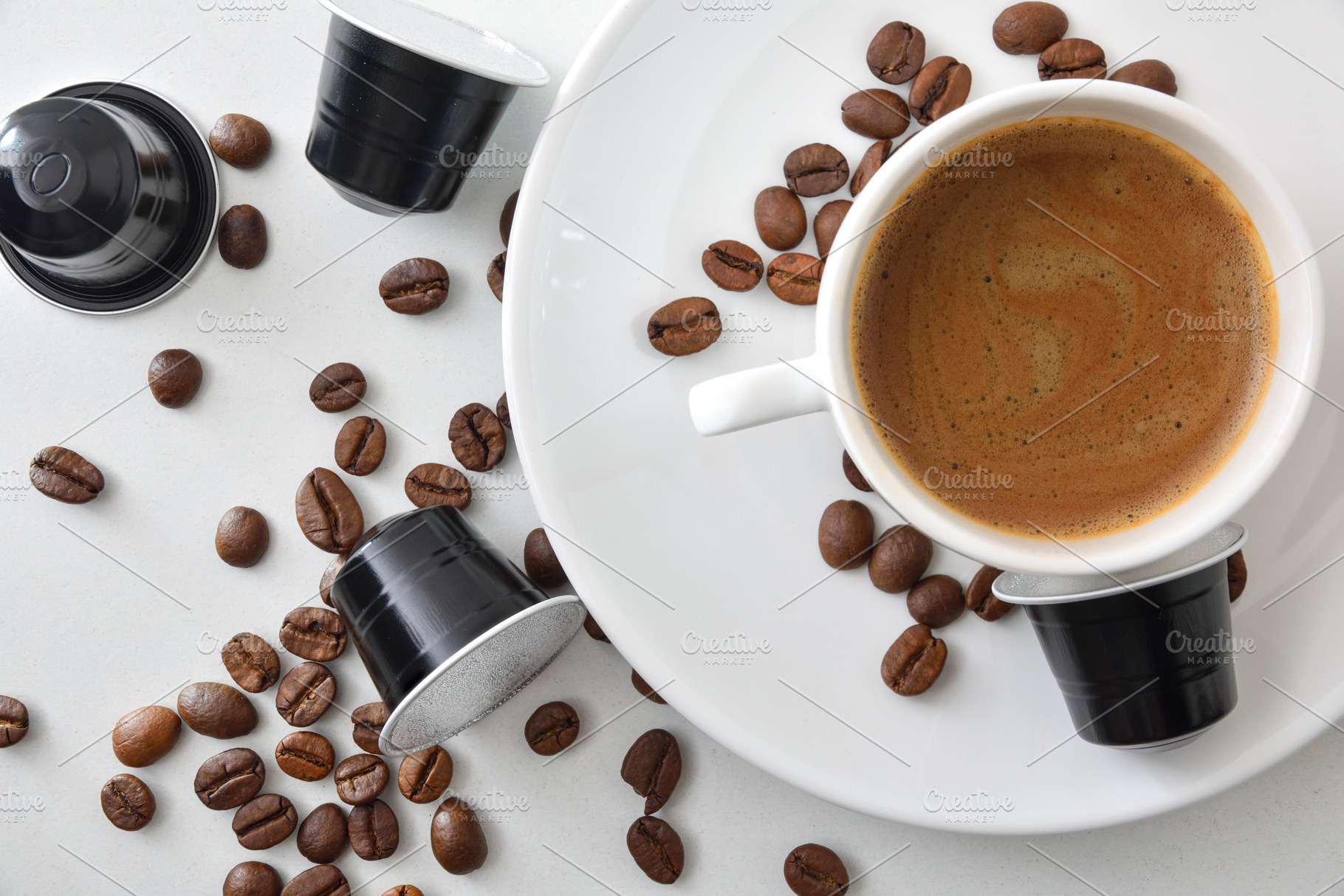 Espresso cup on a plate on white table with capsules, a Food & Drink Photo by Davizro's Market