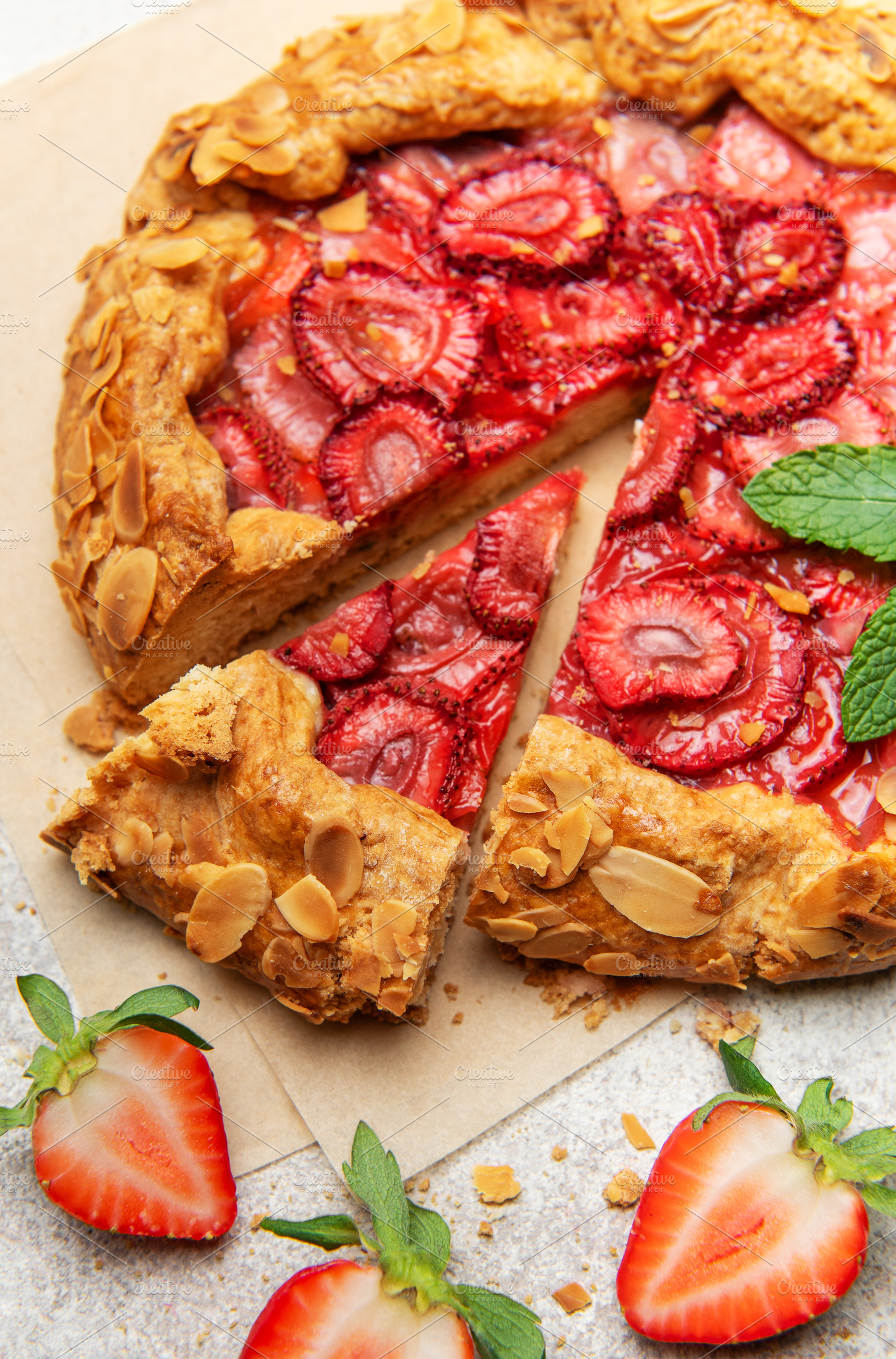 Delicious homemade strawberry galette with almond petals baking, a Food & Drink Photo by Olena Rudo