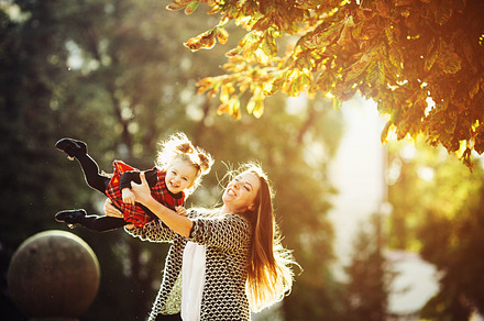 Mother and little daughter playing in a park containing mom, kid, and mother