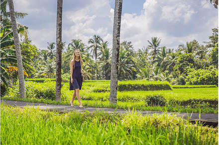 Woman walking in the rice field Bali, a Nature Photo by Elizaveta Galitskaya