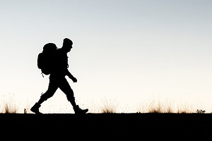 Silhouette of a hiker walking with, a Sports & Recreation Photo by MistyDay