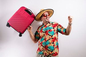 Happy man ready for vacation with suitcase., a Holiday Photo by karrastock