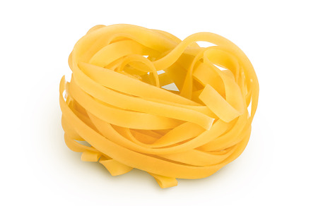 Raw tagliatelle pasta isolated on, a Food & Drink Photo by NataPhoto