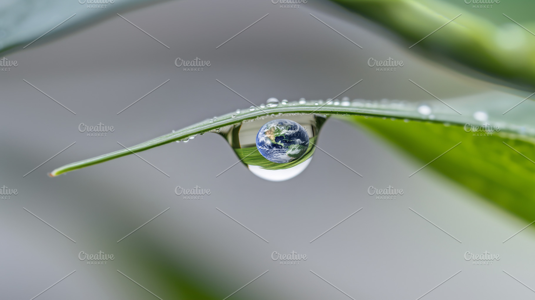 Earth Day concept with globe in Water droplet reflecting sky and, a Photo by Dvoevnore photos