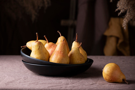 Sweet pears in rustic style on the dark background, a Food & Drink Photo by oxana.denezhkina