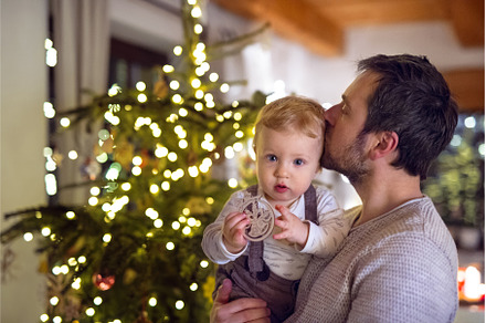Father showing christmas tree to, a Holiday Photo by HalfPoint