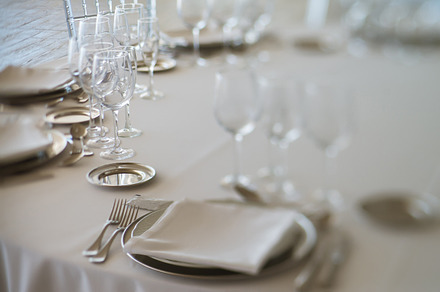 Elegant table set at fine restaurant containing dinner, plate, and decoration