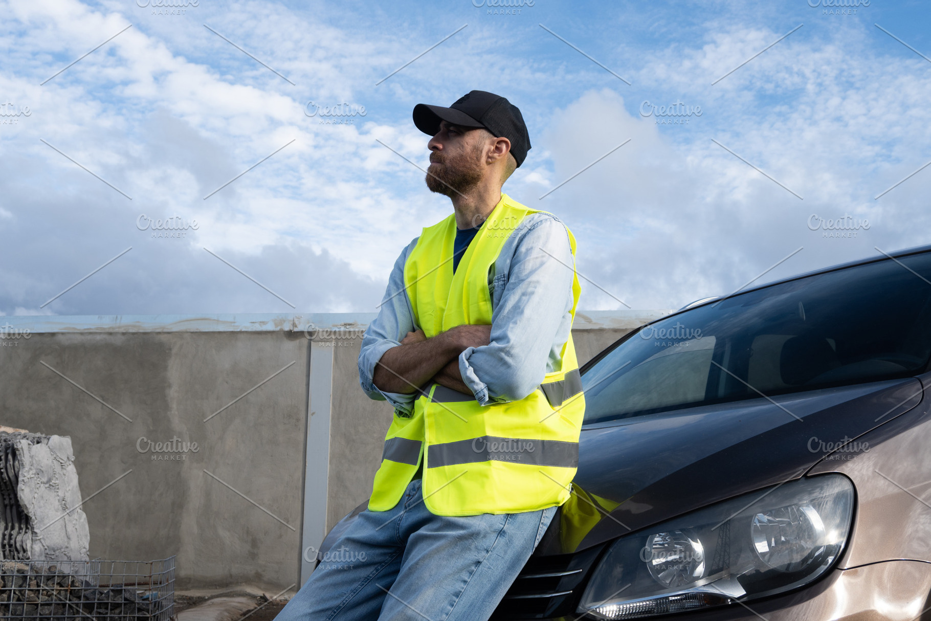 Young man wearing reflective vest beside broken-down car on roadside, a Person Photo by etorres69