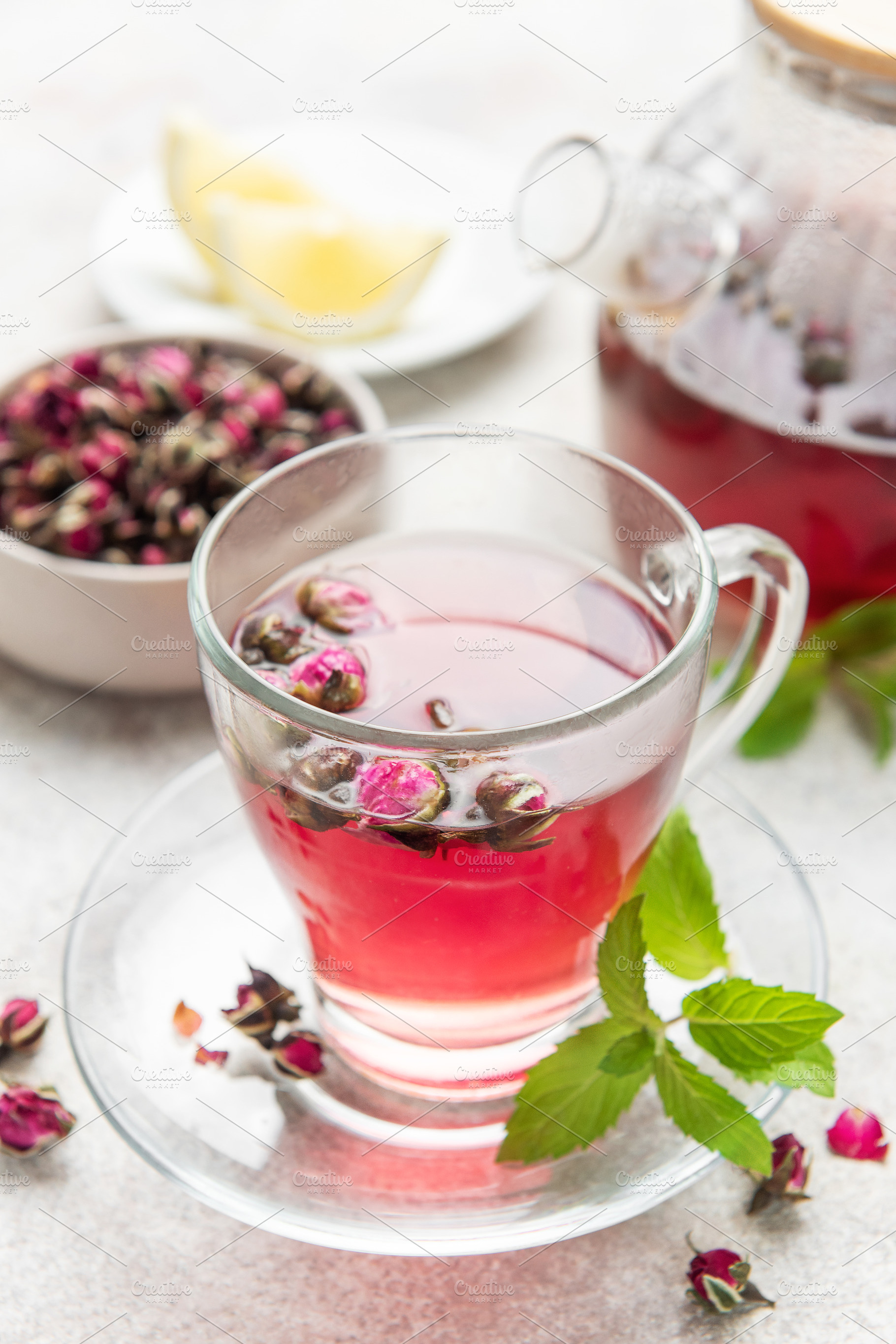 Rose tea in clear cup with mint and dried buds, a Food & Drink Photo by Olena Rudo