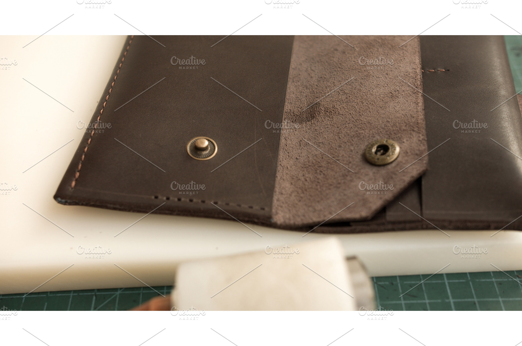 Close-up of handmade leather wallet, an Industrial Photo by volodymyrshtun13795