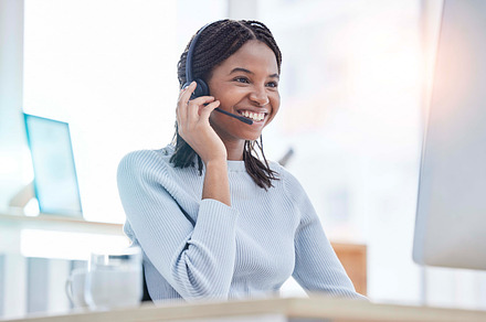 Consulting, call center and black woman at computer for customer service online at office. Technical support professional client communication with headset mic at workplace in Nigeria., a Photo by Peopleimages.com