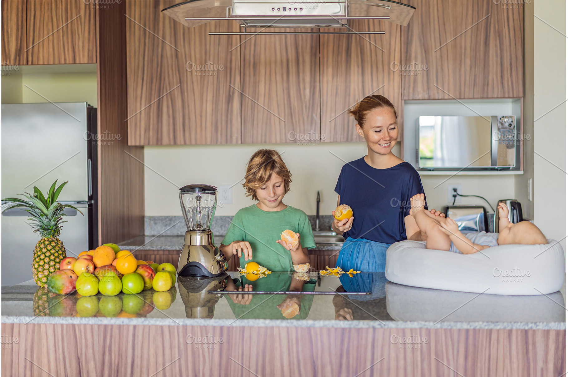 Mother and son preparing smoothie in, a Person Photo by Elizaveta Galitskaya