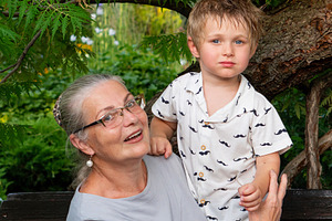 Grandmother holding young grandson, a Person Photo by Elena Vagengeim