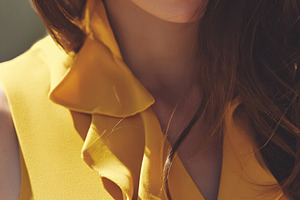 Elegant young woman closing eyes, wearing a stylish ruffled yell, a Photo by Studio ANNA