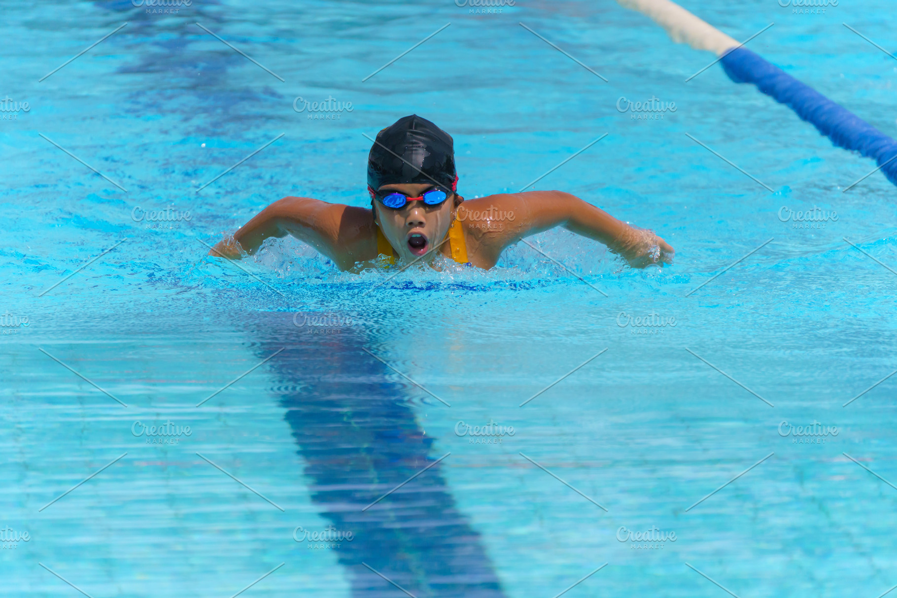 Swimmer child swims butterfly swimming style in a race swimming, a Sports & Recreation Photo by Casanowe-studio