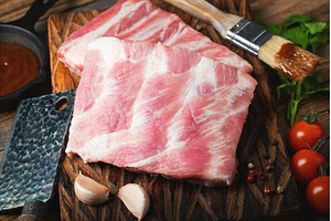 Raw pork ribs with spices, salt and, a Food & Drink Photo by Budarinphoto