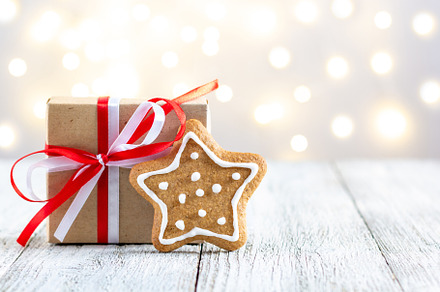 Gingerbread star and box of gift on bokeh lights background, a Holiday Photo by dashtik