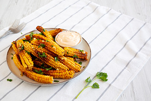 Homemade Spicy Corn Ribs with Mayo on a Plate, side view. Copy s, a Food & Drink Photo by LiudmylaChuhunova
