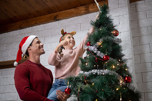 Father and daughter decorating Christmas tree together, a Holiday Photo by etorres69