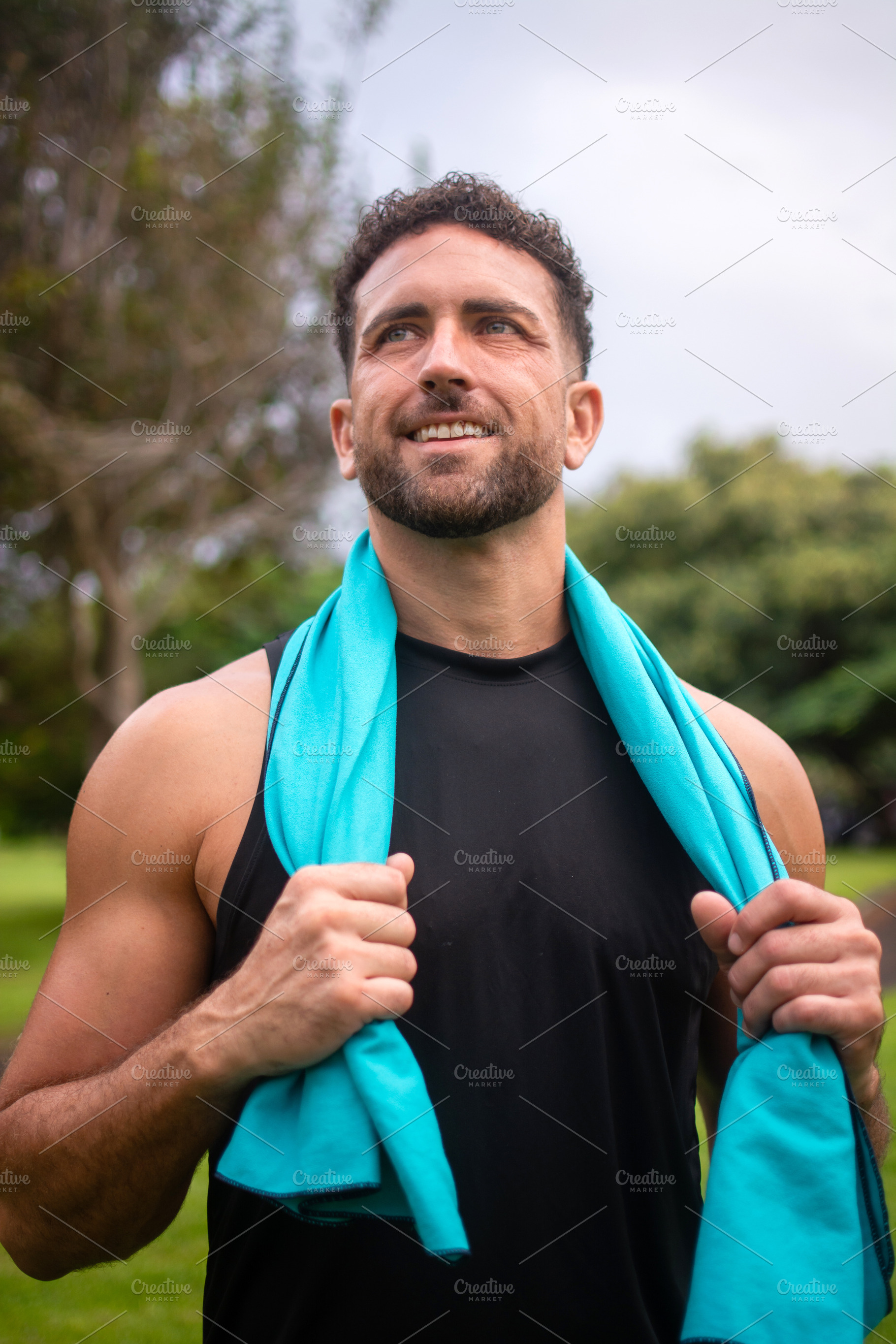 Smiling athletic man resting after fitness workout in green park, a Photo by etorres69