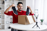 Unboxing Video. Arab Male Blogger Recording Content For His Blog At Home, a Photo by Prostock-Studio (Thumbnail 1 of 2)