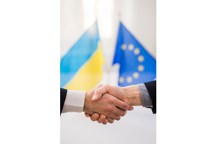 Handshake between the European Union, a Business Photo by HalfPoint