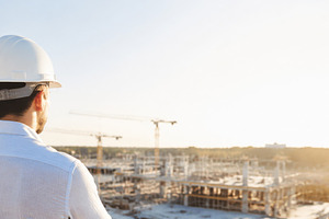Construction worker overlooks site u, a Photo by Dvoevnore photos