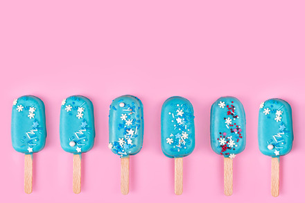 Blue icecream popsicles on pink, a Food & Drink Photo by IMG Studio